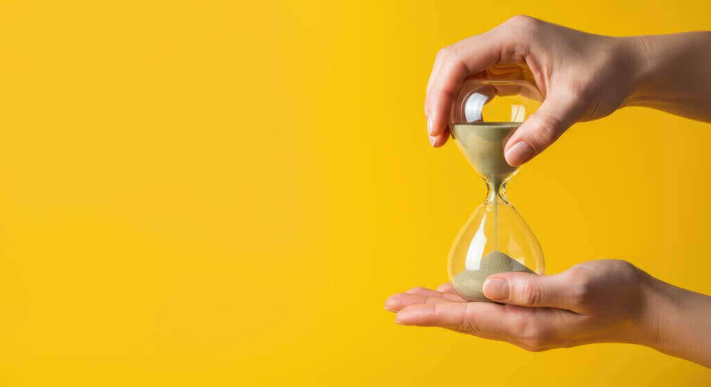 Hourglass in hands symbolizing the importance of webinar duration